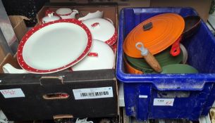 Two Le Creuset casseroles, one orange, one dark green a green Le Creuset saucepan and a frying