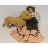 Early 20th century dachshund soft toy and a doll with fabric painted face, straw hat, spotted