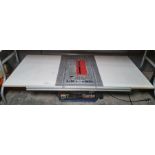 A Clarke 10" table saw mounted on 134 x66 cms table