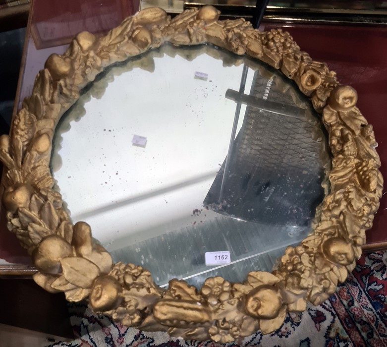 Circular mirror in moulded frame decorated with fruits, 59.5cm