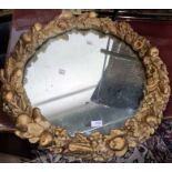 Circular mirror in moulded frame decorated with fruits, 59.5cm