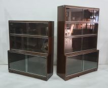 Two 20th century mahogany bookcases, each in the sectional style, with sliding glass doors (2)