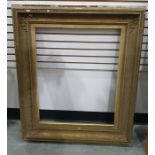 19th century gilt plaster and wood picture frame of rectangular form with stiff leaf corners and