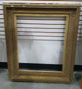 19th century gilt plaster and wood picture frame of rectangular form with stiff leaf corners and