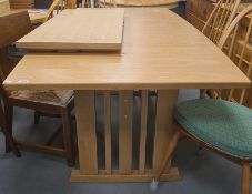 20th century light oak extending dining table on pillar end supports