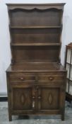 20th century oak dresser with shelves above two drawers and two cupboard doors, on rectangular