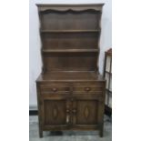 20th century oak dresser with shelves above two drawers and two cupboard doors, on rectangular