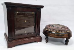 Mahogany cabinet of small proportions, moulded corners above glazed door enclosing four drawers,