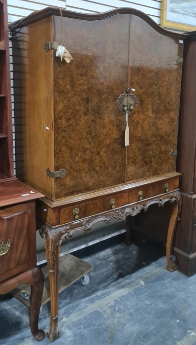 20th century burr walnut cocktail cabinet with arched top above two doors, two drawers, on