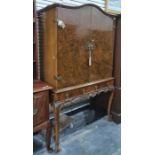 20th century burr walnut cocktail cabinet with arched top above two doors, two drawers, on