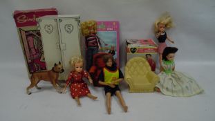 Box of vintage Sindy and Barbie dolls, some with clothing and loose Sindy furniture and accessories