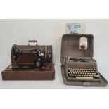 Royal De-Luxe portable typewriter in carrying case and with instructions and a Singer sewing machine
