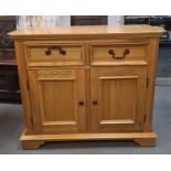 Modern oak cabinet, the rectangular top with canted corners, two drawers, two cupboard doors,