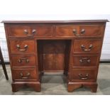 Reproduction mahogany kneehole desk with an arrangement of two long and six small drawers around the