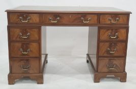 20th century mahogany pedestal desk with green leather inset top and nine assorted drawers, on