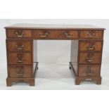 20th century mahogany pedestal desk with green leather inset top and nine assorted drawers, on