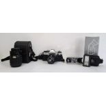 Canon AE1 Programme camera, a Sigma Zoom 1-4/5.6 lens, compact pair of binoculars and one other