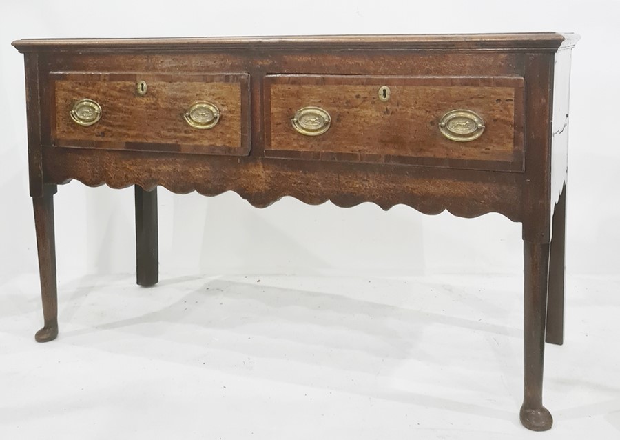George III oak sideboard having ogee moulded edge, the two frieze drawers with crossbanding, later