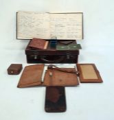 Small leather suitcase and contents including early 20th century leather stationery case modelled as