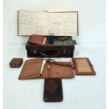 Small leather suitcase and contents including early 20th century leather stationery case modelled as