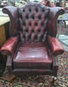 Pair of red leather button back wing back office reception armchairs, on cabriole legs (2)