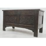 Possibly 18th century oak coffer having triple framed panel top, lunette carved frieze, the two