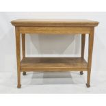 Light oak two-tier side table, circa 1900, the rectangular top with moulded edge, on square