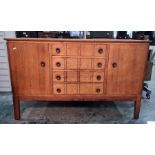Gordon Russell oak sideboard with four central drawers flanked by cupboard doors, shaped legs,