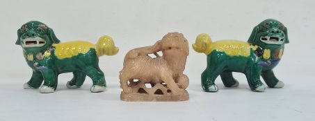 Pair Chinese green and yellow glazed Buddhist lions, 11cm and a carved soapstone model of a lion,