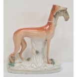 Staffordshire flatback greyhound holding rabbit, 28cm high