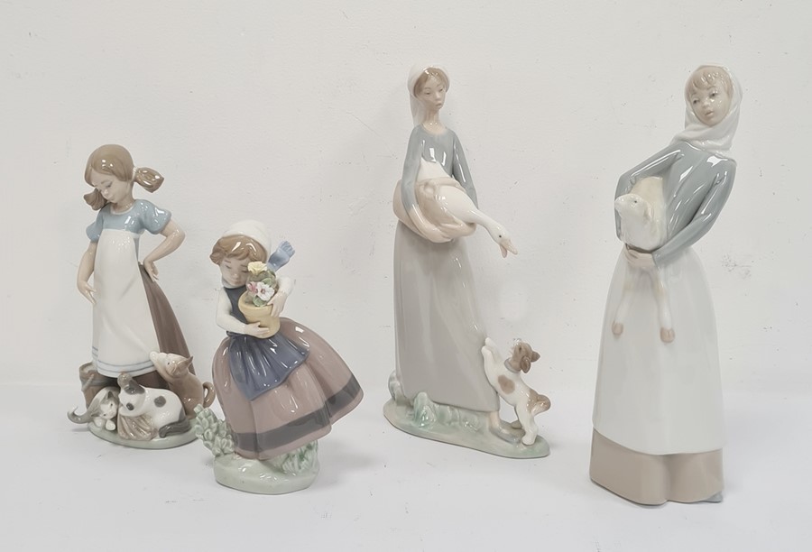 Lladro figure of a girl with kittens, a Lladro figure of a girl with goose and puppy, a Lladro