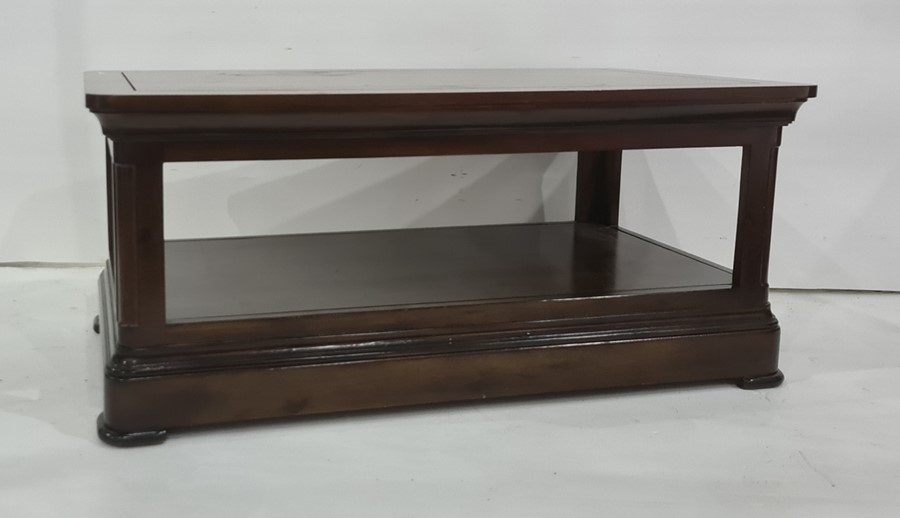 Modern rectangular two-tier coffee table with rounded corners, on plinth base