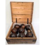 Set of eight early 20th century wooden lawn bowls with bone marking dots and a smaller turned wooden
