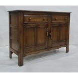 Ercol dark elm dresser base with two short drawers above two cupboard doors