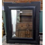 19th century ebonised wall mirror with wavy moulded border, central rectangular bevelled mirror