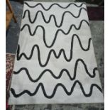 Modern rug with black undulating lines, on a white ground, 132cm x 198cm  Condition