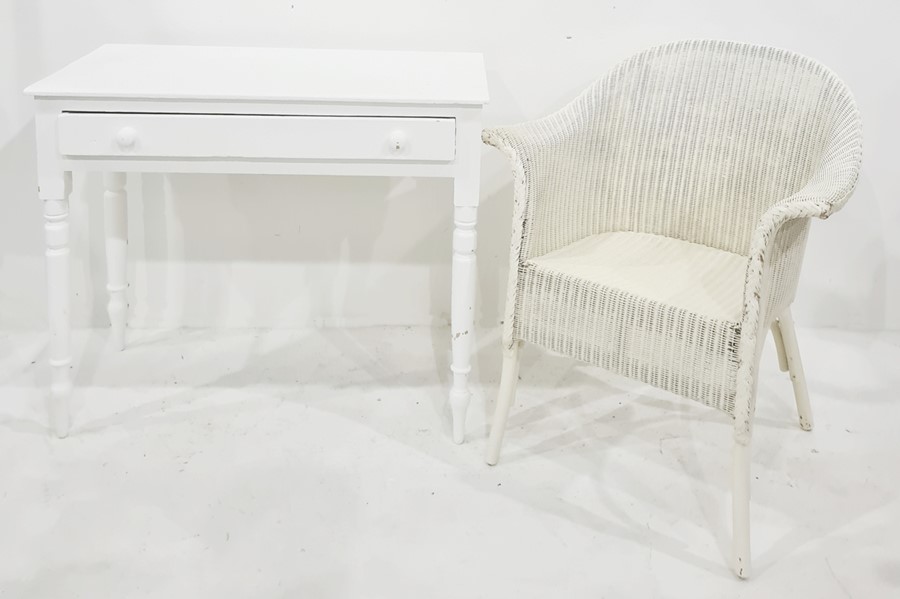 White painted single drawer side table on turned supports, pad feet and a lloyd loom style chair (