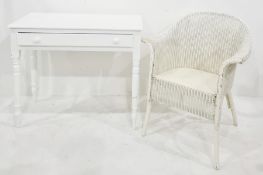 White painted single drawer side table on turned supports, pad feet and a lloyd loom style chair (