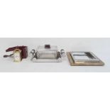 Chrome bakelite and pressed glass cigarette box of Art Deco design on mirrored two handled base, a