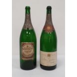 Two empty jeroboam bottles, one with an Extra Stout Guinness label with facsimile signature and '