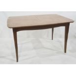 Early 20th century extending dining table in the manner of Heals, a shaped top on four shaped legs