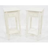 Pair of white painted bedside tables with single drawers and united undertiers, on turned supports