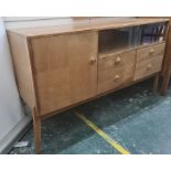 Mid century walnut sideboard, the rectangular top above glass sliding doors, above four drawers,