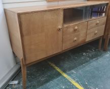 Mid century walnut sideboard, the rectangular top above glass sliding doors, above four drawers,