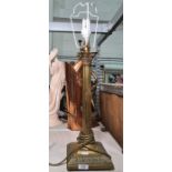 Brass table lamp formed as a corinthian column on stepped foot with acanthus design and four ball