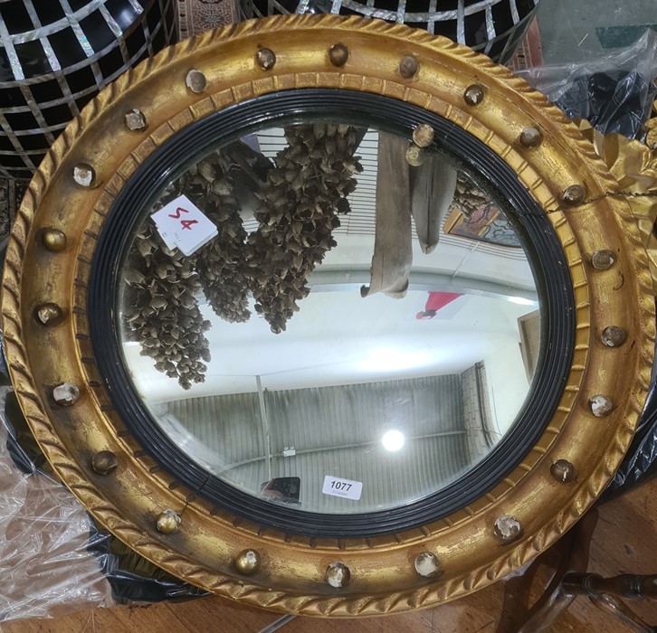 Possibly late 19th century circular mirror with slightly convex glass, the frame surmounted by