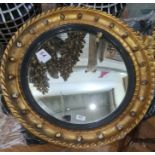 Possibly late 19th century circular mirror with slightly convex glass, the frame surmounted by