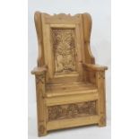 Child's wingback chair with carved backsplat featuring flowers in vase, lift box seat