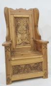 Child's wingback chair with carved backsplat featuring flowers in vase, lift box seat