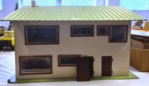 20th century doll's house with lift-up roof and front opening with green roof and white painted